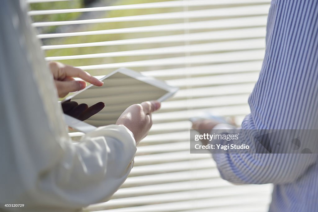 Close up of using digital tablet in meeting