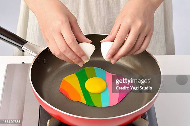 women bake in a frying pan colorful egg - bright food stock pictures, royalty-free photos & images