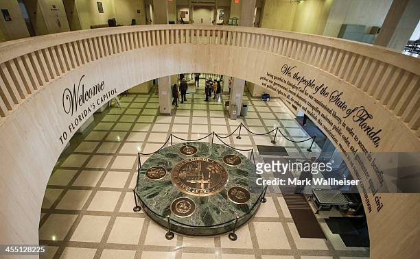 School group gathers around Chaz Steven's Festivus pole made out of beer cans in the rotunda of the Florida Capitol December 11, 2013 in Tallahassee,...
