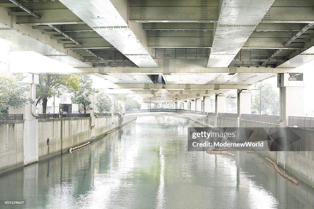 River and sunshine under viaduct