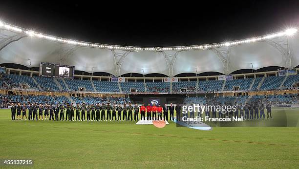 The teams of Pakistan and Sri Lanka line up during a minute of silence for Nelson Mandela prior to the first Twenty20 International match between...