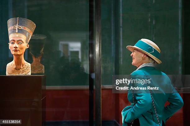 Queen Margrethe II of Denmark regards intently the bust of 3,400-year-old Egyptian beauty Queen Nefertiti on September 10, 2014 in Berlin, Germany....