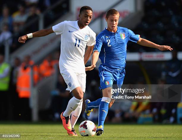 Christopher Willock of England is tackled by Leonardo Rivoira of Italy during the International match betweeen Engand Under 17 and Italy Under17 at...