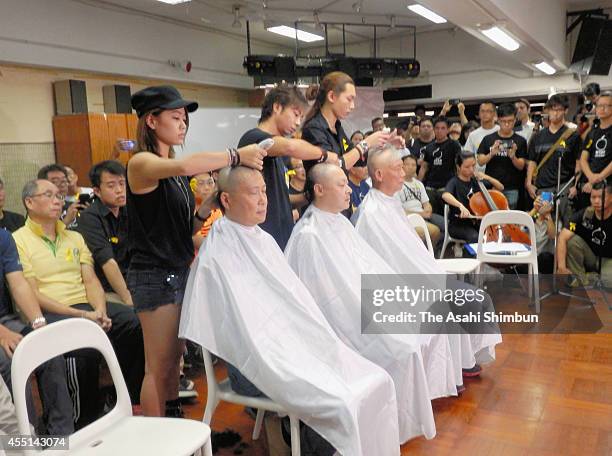 Leaders of the 'Occupy Central' movement Chan Kin-man, Benny Tai and Chu Yiu-ming have their heads shaved in protest against Beijing's decision over...