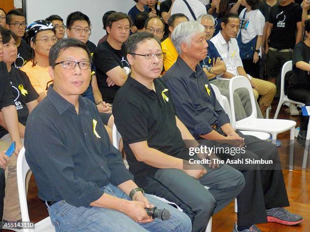 Leaders of the 'Occupy Central' movement Chan Kin-man, Benny Tai and Chu Yiu-ming prepare to have their heads shaved in protest against Beijing's...