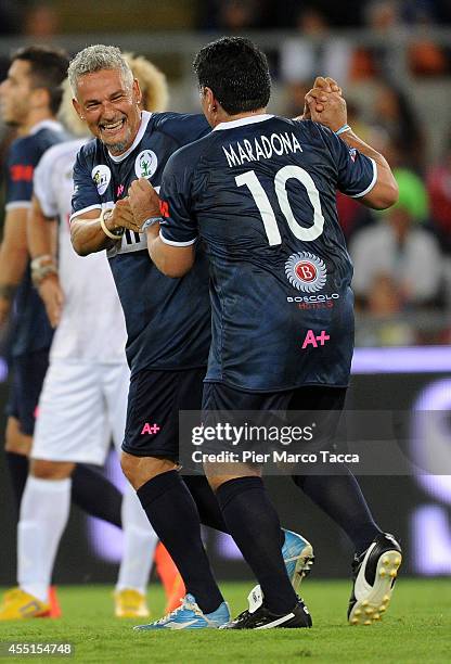 Roberto Baggio and Diego Maradona in action during Interreligious Match for Peace at Olimpico Stadium on September 1, 2014 in Rome, Italy.