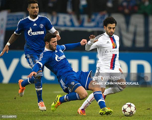 Basel's Egyptian midfielder Mohamed Salah is intercepted by Schalke's defender Sead Kolasinac during the UEFA Champions League group E football match...