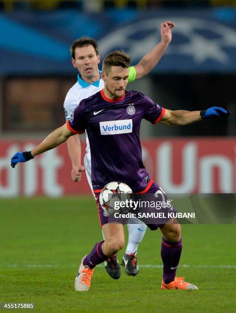 Austria's midfielder James Holland vies with Zenit's midfielder Konstantin Zyryanovvie during the UEFA Champions League group G football match FK...