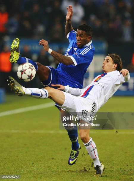 Jefferson Farfan of Schalke and Kay Voser of Basel challenge for the ball during the UEFA Champions League Group E match between FC Schalke 04 and FC...
