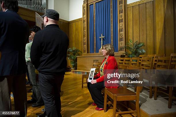 Sits alone and holds a photo of her daughter Lauren Rousseau who was a substitute teacher when she was killed at Sandy Hook Elementary School nearly...