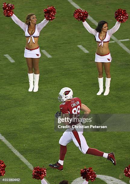 Tight end John Carlson of the Arizona Cardinals runs onto the field before the NFL game against the San Diego Chargers at the University of Phoenix...