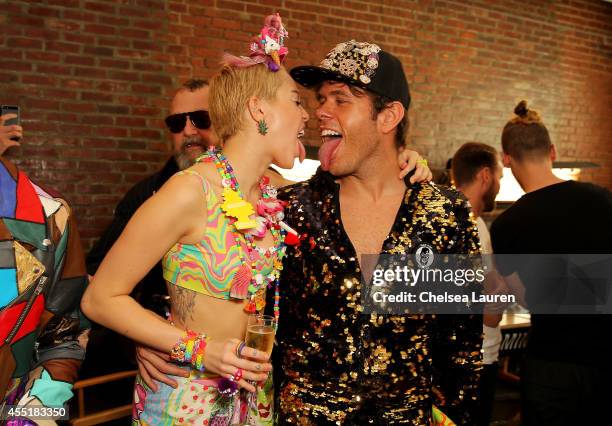 Miley Cyrus and Perez Hilton pose baskstage at Jeremy Scott fashion show during MADE Fashion Week Spring 2015 at Milk Studios on September 10, 2014...