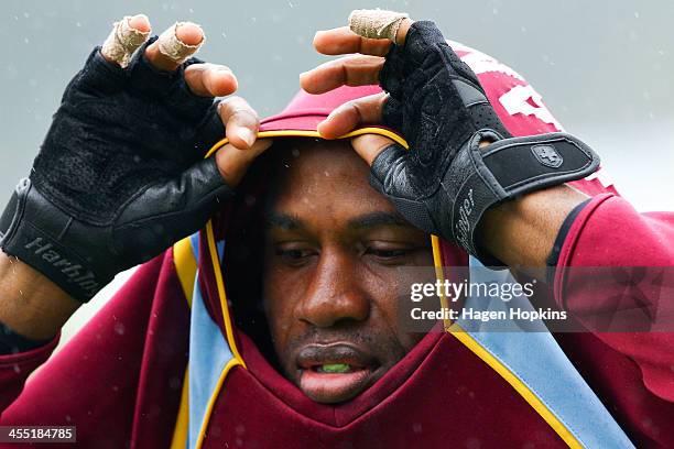 Marlon Samuels of the West Indies shelters from the rain during a rain delay on day two of the Second Test match between New Zealand and the West...