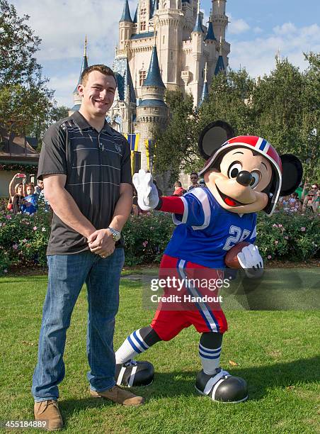 In this handout photo provided by Disney Parks, Texas A&M quarterback Johnny Manziel poses with Mickey Mouse at the Magic Kingdom park at Walt Disney...