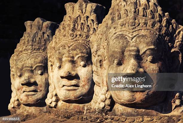 stone statues at the entrance to bayon temple - angkor thom fotografías e imágenes de stock