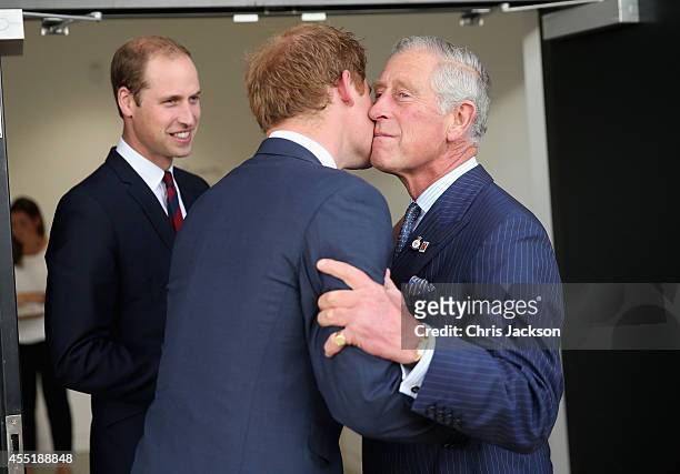 Prince Charles, Prince of Wales kisses his son Prince Harry as Prince William, Duke of Cambridge looks on ahead of the Invictus Games Opening...