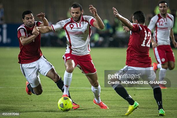 Tunisia's midfielder Yassine Chikhaoui vies for the ball with Egypt's defender Ahmed Fathy and Egypt's midfielder Hazem Emam during the 2015 African...