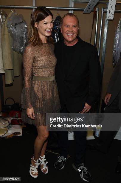 Hanneli Mustaparta and designer Michael Kors prepare backstage at the Michael Kors fashion show during Mercedes-Benz Fashion Week Spring 2015 at...