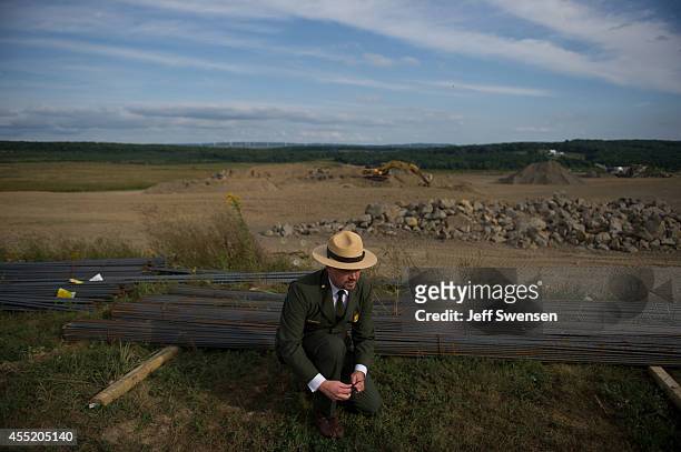 Jeff Reinbold, superintendent of the National Park Service in Western Pennsylvania, ties his shoe during a media tour of the construction site at the...