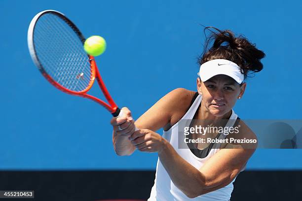 Casey Dellacqua of Australia plays a backhand in her quater-finals match against Monique Adamczak of Australia in the Australian Open 2014 Qualifying...