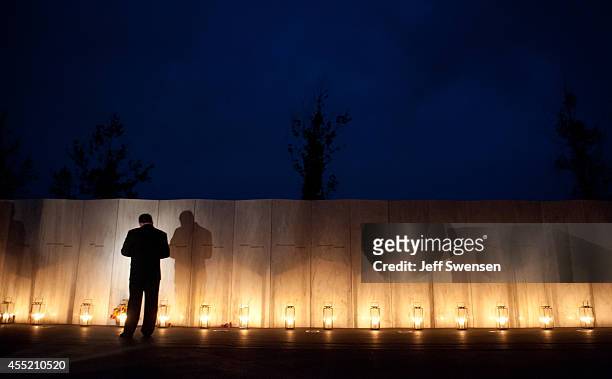Visitors walk along the wall of names of passengers who perished in the 9/11 terrorist attacks on the eve of the 13th anniversary of the attacks at...