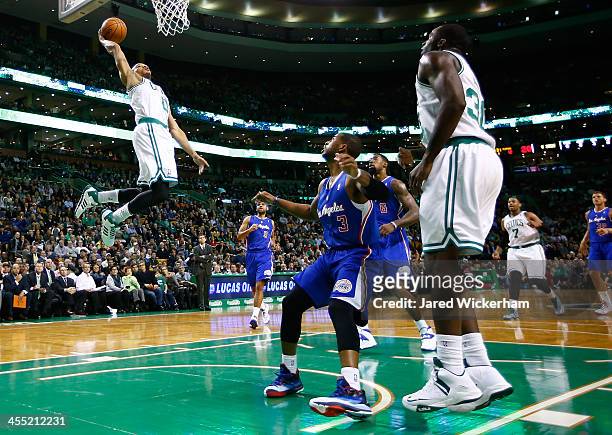 Avery Bradley of the Boston Celtics dunks an alley-oop in the first quarter against the Los Angeles Clippers during the game at TD Garden on December...