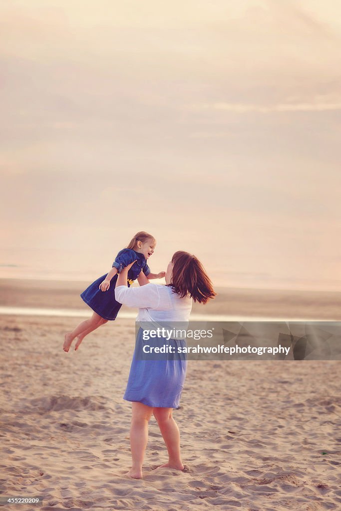 Mother and daughter playing at the beach