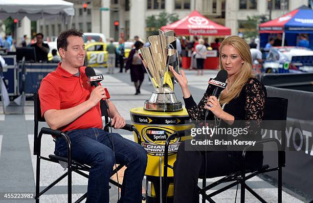 Reporter Nicole Briscoe interviews Kyle Busch, driver of the M&M's Toyota, at a NASCAR Chase Across North America event on September 10, 2014 in...