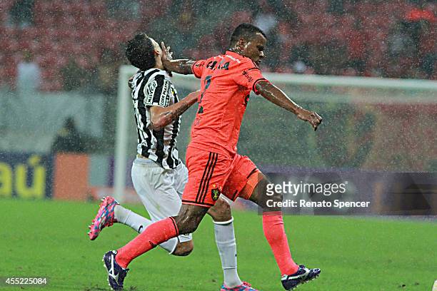 Vitor of Sport Recife battles for the ball with Thiago Ribeiro of Santos during the Brasileirao Series A 2014 match between Sport Recife and Santos...