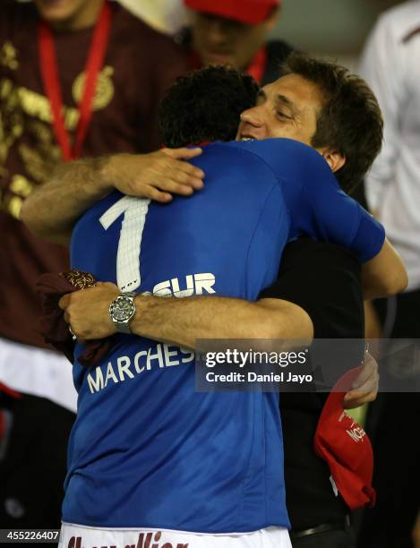 Agustin Marchesin goalkeeper of Lanus celebrates with Guillermo Barros Schelotto, coach of Lanus, at the end of the final match between Lanus and...