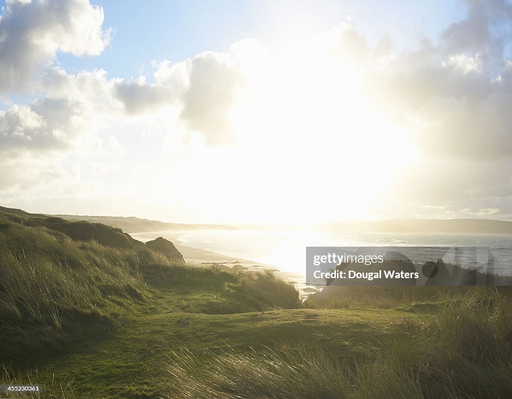 Sunburst over dunes on Atlantic coastline