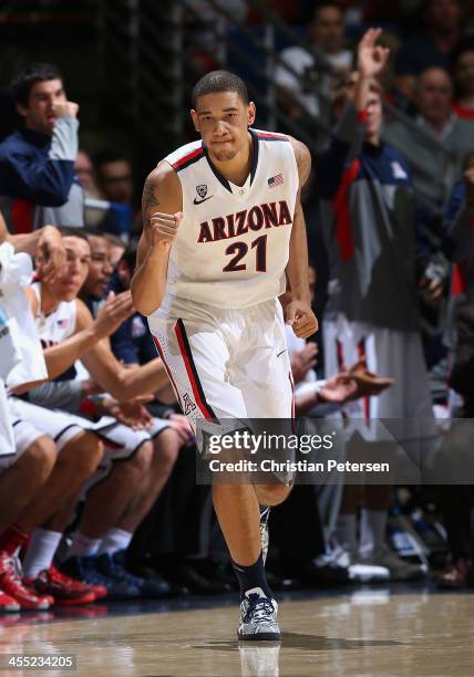 Brandon Ashley of the Arizona Wildcats celebrates after hitting a three point shot against the New Mexico State Aggies during the second half of the...