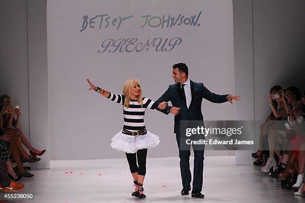 Designer Betsey Johnson and dancer Tony Dovolani walk the runway at Betsey Johnson during Mercedes-Benz Fashion Week Spring 2015 at The Salon at...