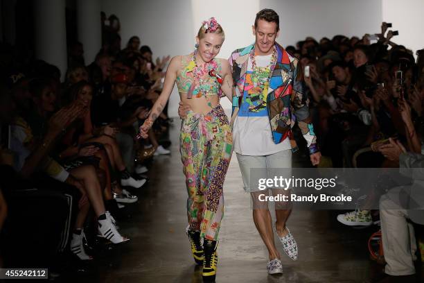 Miley Cyrus and Jeremy Scott walk the runway at Jeremy Scott during MADE Fashion Week Spring 2015 at Milk Studios on September 10, 2014 in New York...