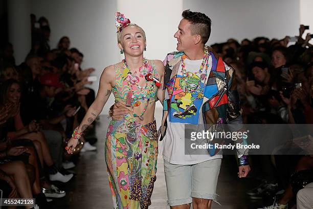 Miley Cyrus and Jeremy Scott walk the runway at Jeremy Scott during MADE Fashion Week Spring 2015 at Milk Studios on September 10, 2014 in New York...