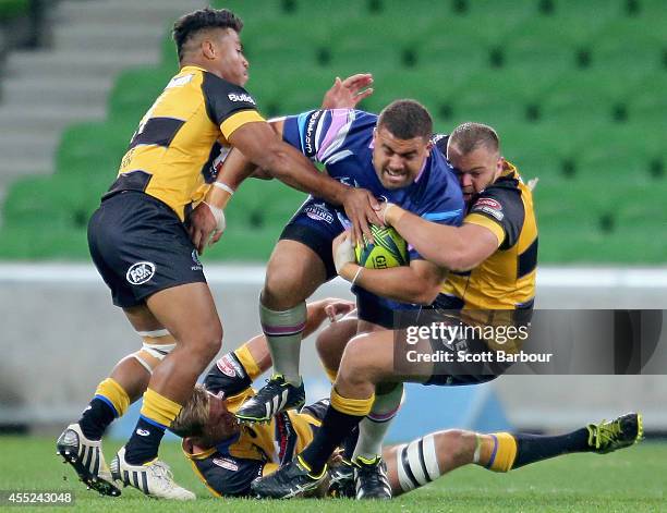 Paul Alo-Emile of the Rising is tackled during the round four National Rugby Championship match between Melbourne Rising and Perth Spirit at AAMI...