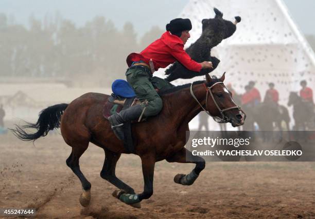 Kyrgyz rider plays the traditional Central Asian sport Buzkashi also known as Kok-Boru or Oglak Tartis in the first World Nomad Games in Cholpon-Ata,...