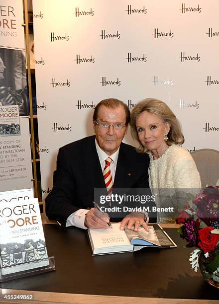 Roger Moore signs copies of his new book "Last Man Standing: Tales from Tinseltown" alongside wife Kristina Tholstrup at Harrods Bookshop on...