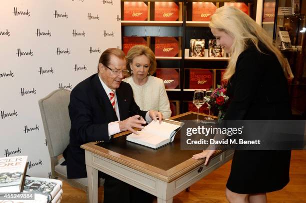 Roger Moore signs copies of his new book "Last Man Standing: Tales from Tinseltown" alongside wife Kristina Tholstrup at Harrods Bookshop on...