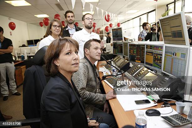 French TV hosts Benjamin Castaldi and Carole Rousseau answer a call during the annual Charity Day event of American global financial services company...