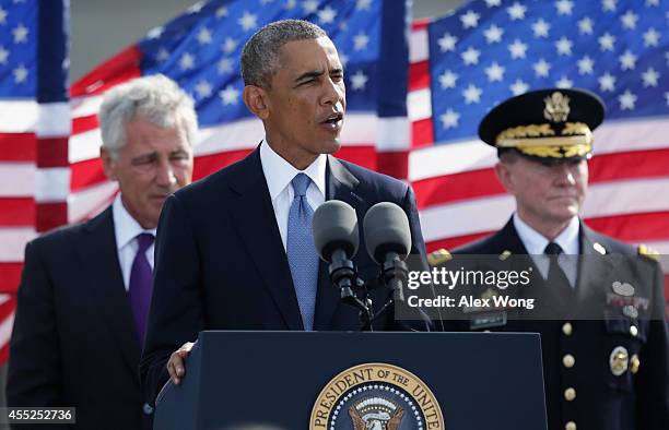 President Barack Obama speaks as Secretary of Defense Chuck Hagel and Chairman of the Joint Chiefs Gen. Martin Dempsey listen during a ceremony to...