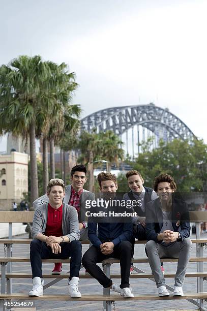 In this handout photo provided by Hausmann Communications, One Direction wax figures from Madame Tussauds are seen at Circular Quay on December 12,...