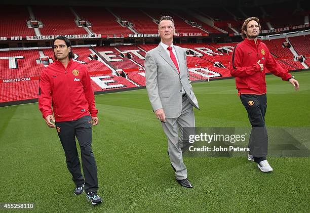 Manager Louis van Gaal of Manchester United walks with new signings Radomel Falcao and Daley Blind ahead of a press conference at Old Trafford on...