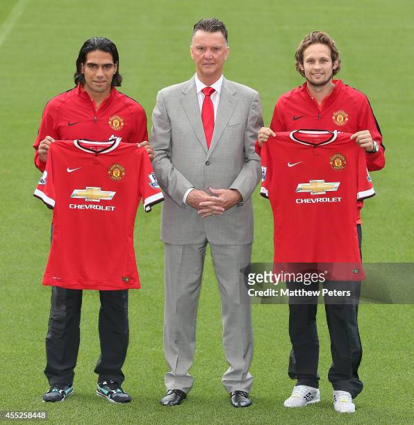 Manager Louis van Gaal of Manchester United poses with new signings Radomel Falcao and Daley Blind ahead of a press conference at Old Trafford on...