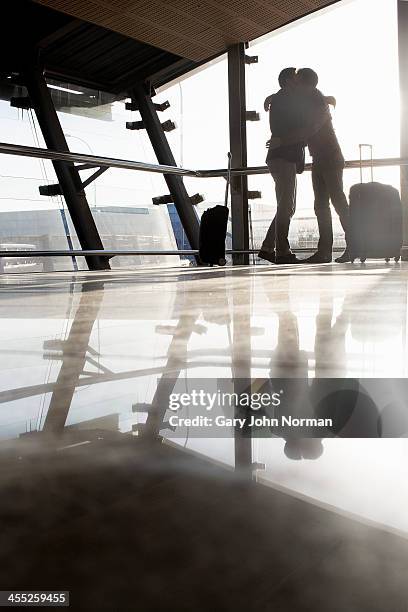 Two Gay Men Embracing At Airport, Foto de stock