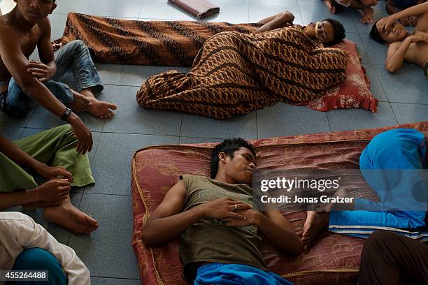 At the orphanage Markaz al-Ishlah lay sleeping inmate children on the floor. Many kids lost their families in the 2004 tsunami disaster and had to...