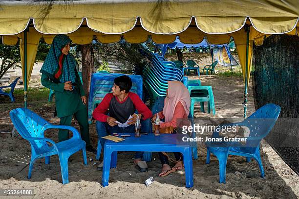 Siti Habiyah, a member of Banda Aceh's Sharia women police, making sure that two lovebirds don't do anything immoral. The tsunami of December 2004...