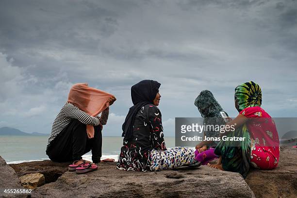 Young women sitting at the Banda Aceh north coast, where some of the largest tsunami waves in December 2004 struck the province. The tsunami of...