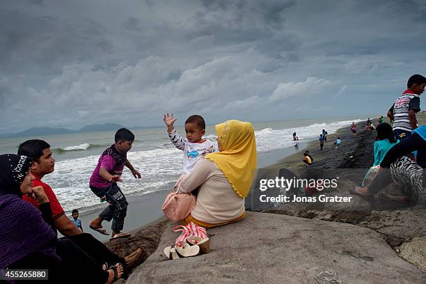 Families gather to socialize at the Banda Aceh north coast, where some of the largest tsunami waves struck the province in 2004. The tsunami of...