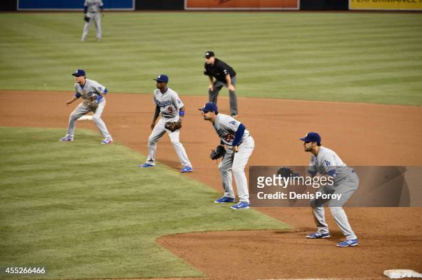 Los Angeles Dodgers players line up using an extreme infield shift as Seth Smith of the San Diego Padres comes up to bat during the twelfth inning of...